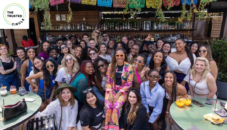 Community Leader, Britt, in the center of a lively group of clinicians, exemplifying the spirit of unity and support inherent in the Trusted Community during a special event.