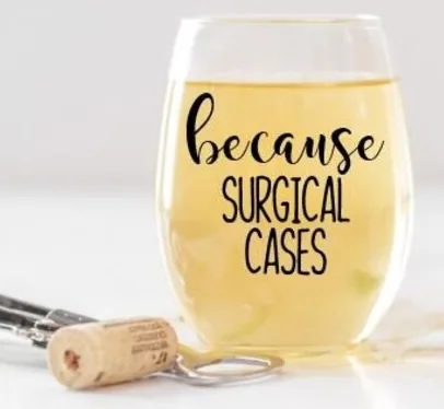 A stemless wine glass filled with a golden liquid, playfully inscribed with 'because SURGICAL CASES,' suggesting a well-deserved break for a surgical tech.